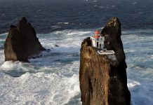 Incredible location for a lighthouse perched on a rock in Iceland’s wild surf